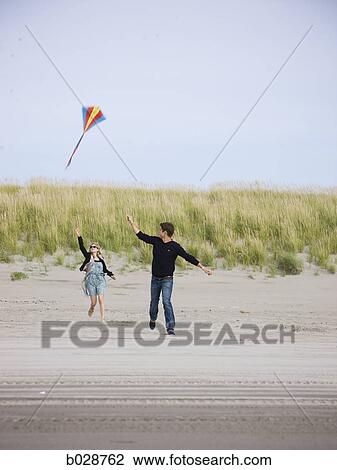 couple flying a kite at the beach View Large Photo Image Stock Image - couple flying a kite at the beach. Fotosearch