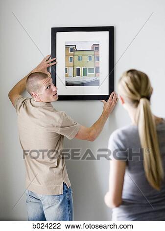 couple hanging a picture View Large Photo Image Stock Image - couple hanging a picture. Fotosearch