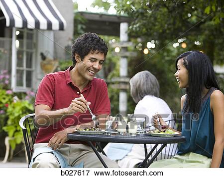 Stock Photo - couple having a meal outdoors. Fotosearch