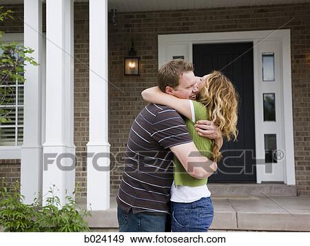 couple hugging in front of a house View Large Photo Image Stock Photo - couple hugging in front of a house. Fotosearch
