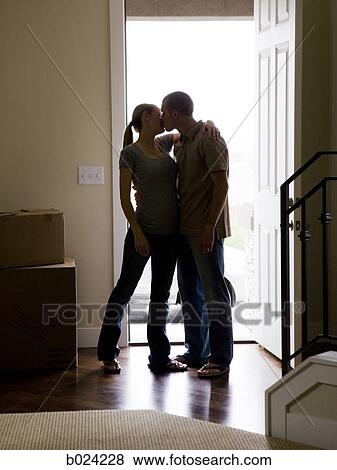 couple kissing in the doorway View Large Photo Image Stock Photo - couple kissing in the doorway. Fotosearch