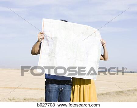 couple looking at a map on the side of the road View Large Photo Image Stock Photo - couple looking at a map on the side of the road. Fotosearch