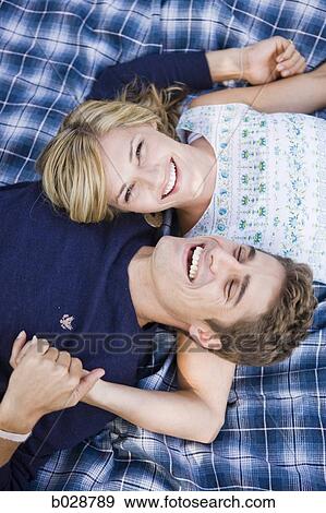 couple lying on a blanket smiling View Large Photo Image Stock Photo - couple lying on a blanket smiling. Fotosearch