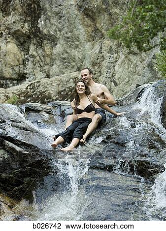 couple on a rock waterslide View Large Photo Image Stock Image - couple on a rock waterslide. Fotosearch