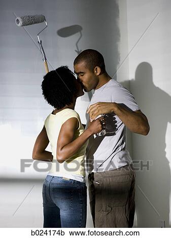 Stock Image - couple painting a room. Fotosearch