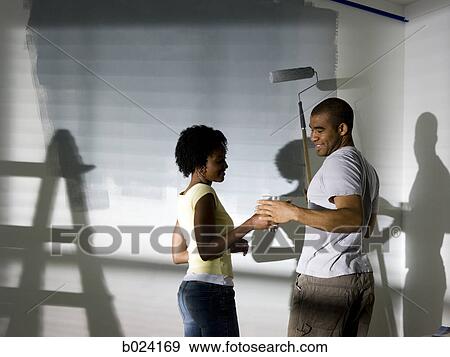 couple painting a room View Large Photo Image Stock Photo - couple painting a room. Fotosearch