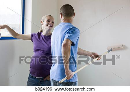 Stock Photograph - couple painting a room. Fotosearch