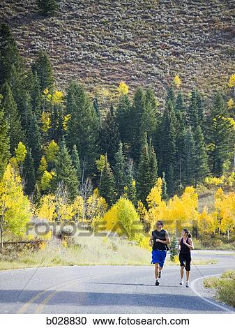 couple running on a mountain road View Large Photo Image Stock Image - couple running on a mountain road. Fotosearch