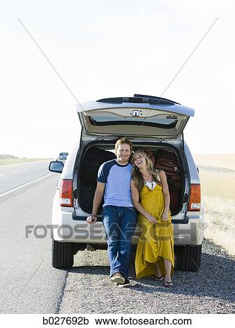 couple sitting in the back of their car on a road trip View Large Photo Image Stock Image - couple sitting in the back of their car on a road trip. Fotosearch