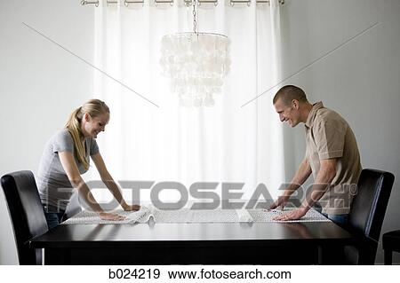 couple spreading out a tablecloth View Large Photo Image Stock Photo - couple spreading out a tablecloth. Fotosearch