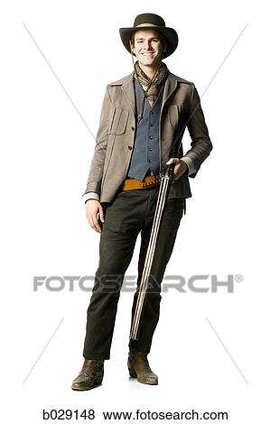 cowboy holding a shotgun View Large Photo Image Stock Photo - cowboy holding a shotgun. Fotosearch