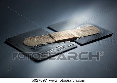 credit card cut in half with a band-aid holding it together View Large Photo Image Stock Photo - credit card cut in half with a band-aid holding it together. Fotosearch