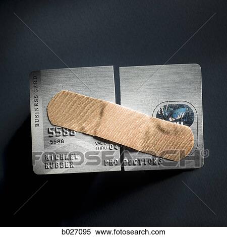 credit card cut in half with a band-aid holding it together View Large Photo Image Stock Photography - credit card cut in half with a band-aid holding it together. Fotosearch