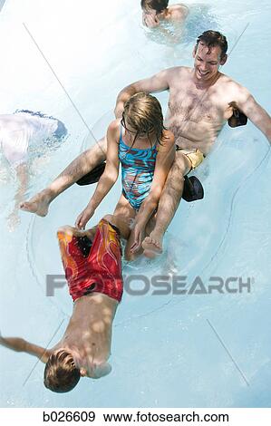 Stock Photo - dad and kids in an inner tube. Fotosearch