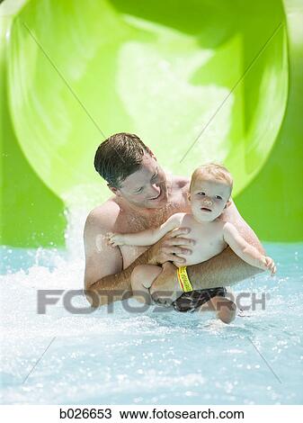 dad and son on a waterslide View Large Photo Image Stock Image - dad and son on a waterslide. Fotosearch