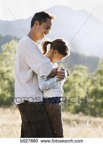Stock Image - dad camping with his kids. Fotosearch