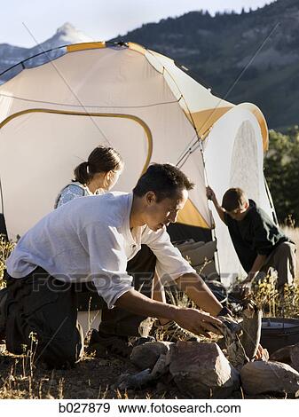 Stock Photo - dad camping with his kids. Fotosearch