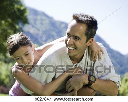 dad in the park playing football with his daughter View Large Photo Image Stock Photo - dad in the park playing football with his daughter. Fotosearch