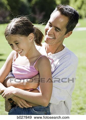 Stock Photo - dad in the park with his daughter. Fotosearch