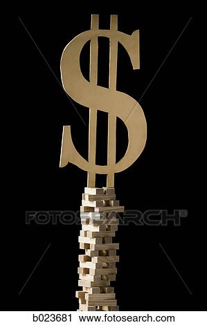Stock Image - dollar symbol perched on a tower of blocks. Fotosearch