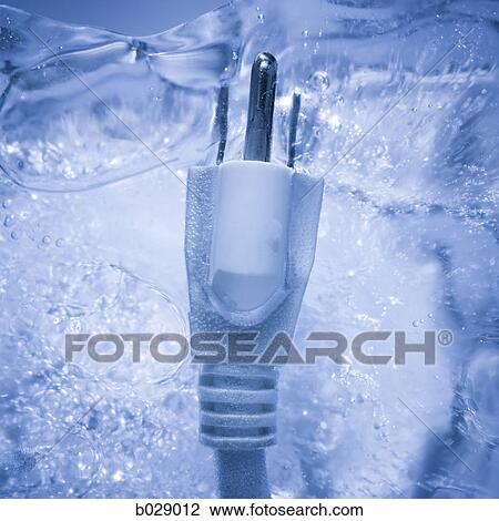 Stock Image - electrical plug frozen in a block of ice. Fotosearch