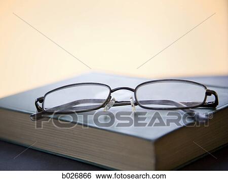 eyeglasses on a book View Large Photo Image Stock Photograph - eyeglasses on a book. Fotosearch