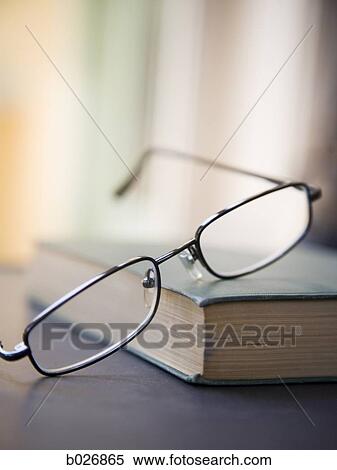 eyeglasses on a book View Large Photo Image Stock Photography - eyeglasses on a book. Fotosearch