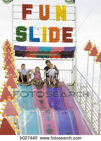 family at the carnival riding on the fun slide together View Large Photo Image Stock Image - family at the carnival riding on the fun slide together. Fotosearch