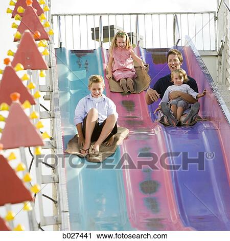 family at the carnival riding on the fun slide together View Large Photo Image Stock Image - family at the carnival riding on the fun slide together. Fotosearch