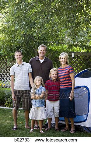 Stock Image - family in the backyard with a tent. Fotosearch