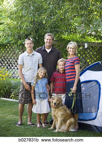 Stock Image - family in the backyard with a tent. Fotosearch