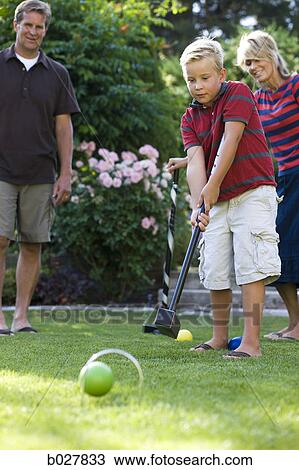 family playing croquet in the backyard View Large Photo Image Stock Image - family playing croquet in the backyard. Fotosearch