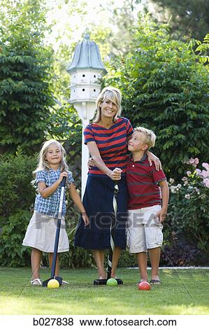 family playing croquet in the backyard View Large Photo Image Stock Photo - family playing croquet in the backyard. Fotosearch