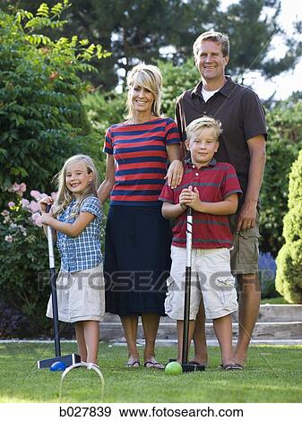 family playing croquet in the backyard View Large Photo Image Stock Photo - family playing croquet in the backyard. Fotosearch