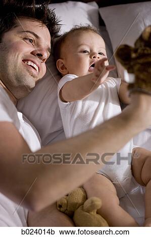 father and baby in bed View Large Photo Image Stock Image - father and baby in bed. Fotosearch