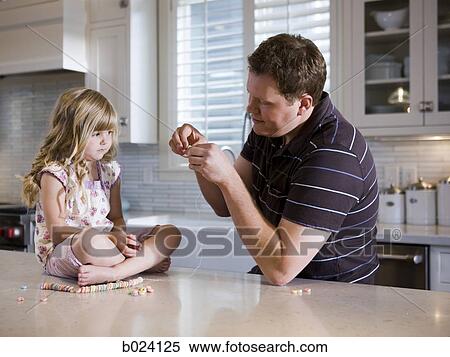 father and daughter making a necklace in the kitchen View Large Photo Image Stock Photography - father and daughter making a necklace in the kitchen. Fotosearch