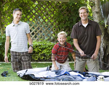 father and son putting up a tent in the backyard View Large Photo Image Stock Photo - father and son putting up a tent in the backyard. Fotosearch