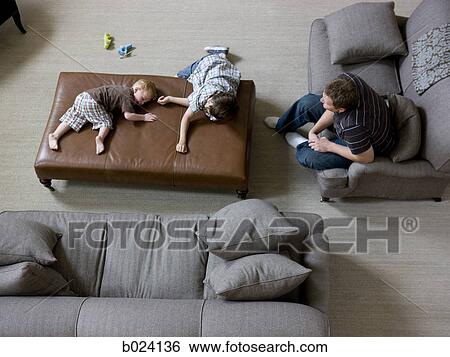 father and two sons in the living room View Large Photo Image Stock Photograph - father and two sons in the living room. Fotosearch