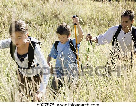 Stock Photography - father hiking with his two kids. Fotosearch