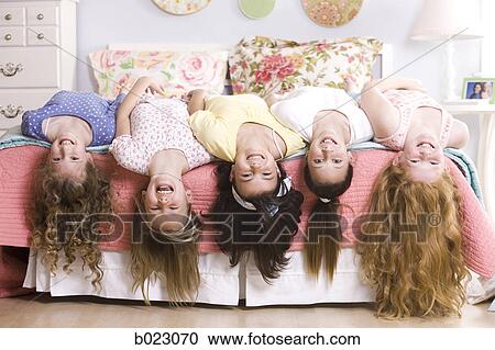 five girls on a bed upside down View Large Photo Image Stock Image - five girls on a bed upside down. Fotosearch