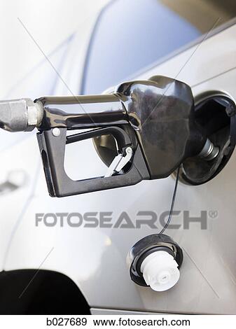 gas pump nozzle in a car View Large Photo Image Stock Photo - gas pump nozzle in a car. Fotosearch