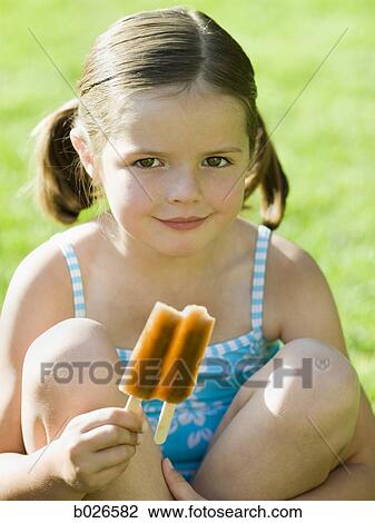 girl eating a popsicle View Large Photo Image Stock Image - girl eating a popsicle. Fotosearch