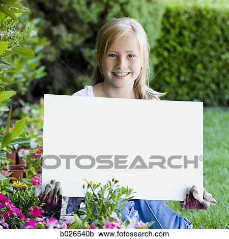 Stock Image - girl holding a blank sign. Fotosearch