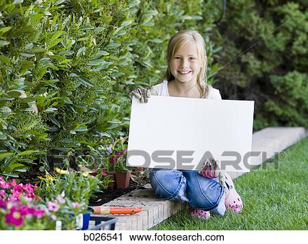 girl holding a blank sign View Large Photo Image Stock Image - girl holding a blank sign. Fotosearch