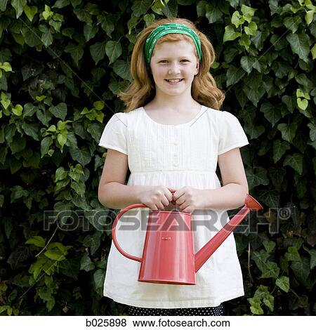 Stock Photo - girl holding a watering can. Fotosearch