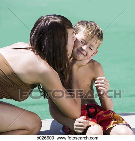 girl kissing her little brother on the cheek View Large Photo Image Stock Image - girl kissing her little brother on the cheek. Fotosearch