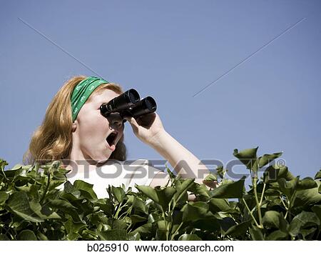 girl looking over a hedge with binoculars View Large Photo Image Stock Image - girl looking over a hedge with binoculars. Fotosearch