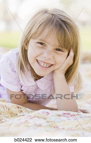 girl lying on a blanket View Large Photo Image Stock Image - girl lying on a blanket. Fotosearch
