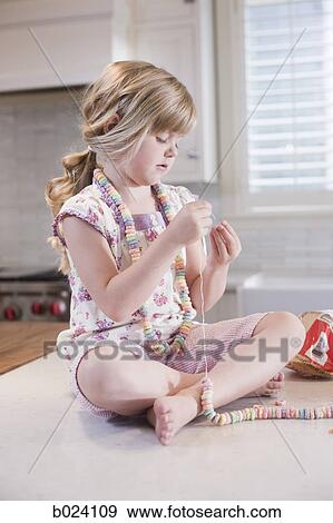 Stock Photo - girl making crafts in the kitchen. Fotosearch