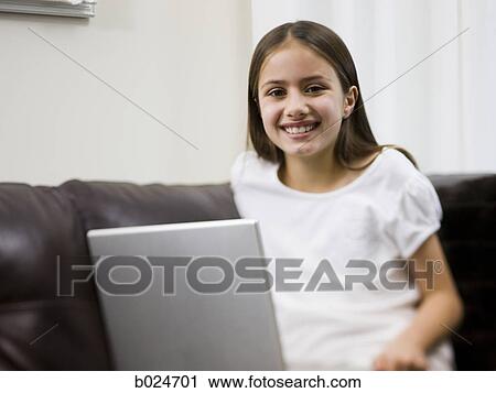 girl on a sofa with a laptop View Large Photo Image Stock Image - girl on a sofa with a laptop. Fotosearch